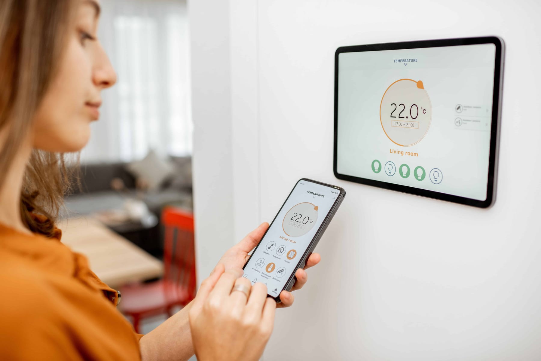Woman controlling heating with a smart