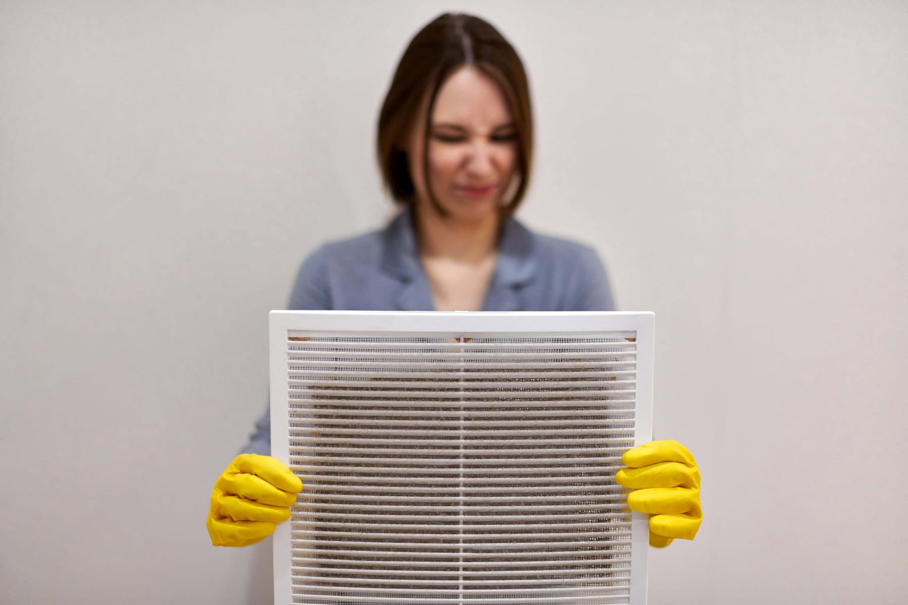 Woman holding dirty and dusty ventilation