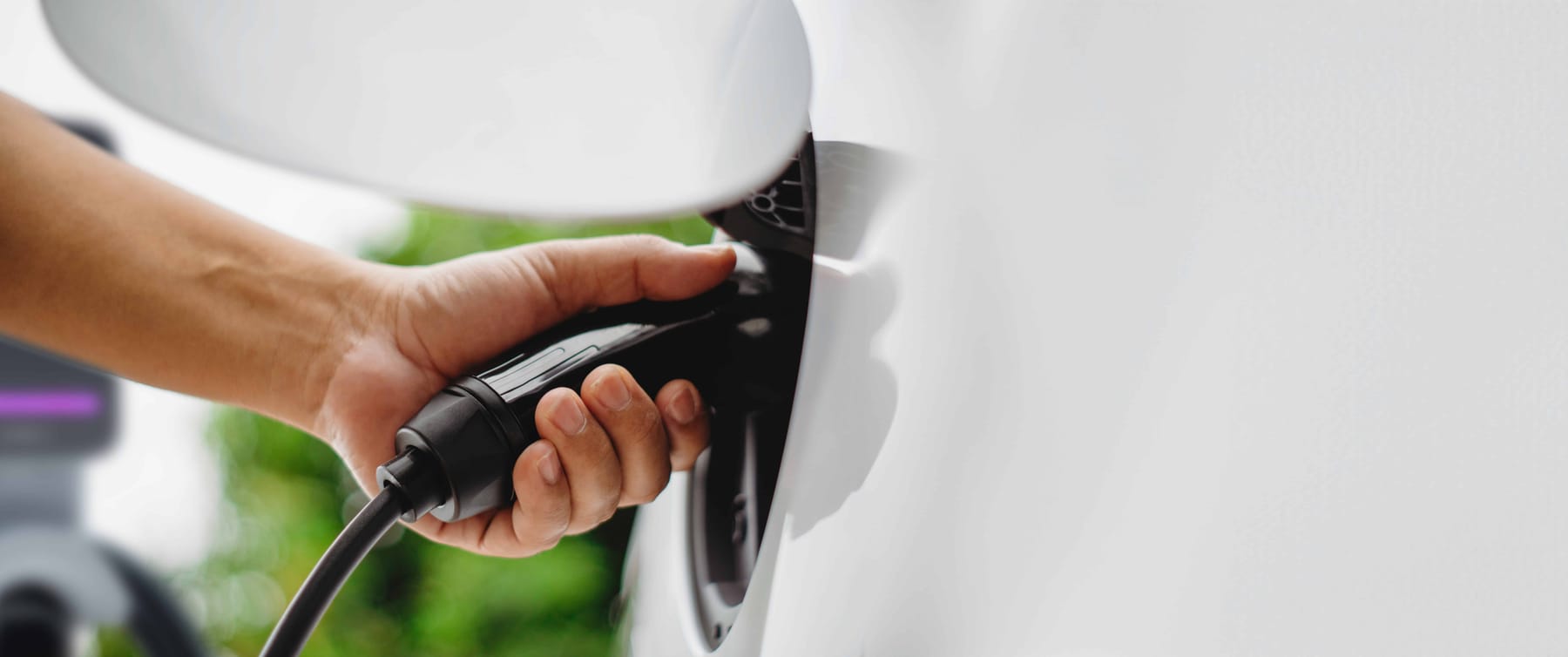 Electric car or EV is charging at station man