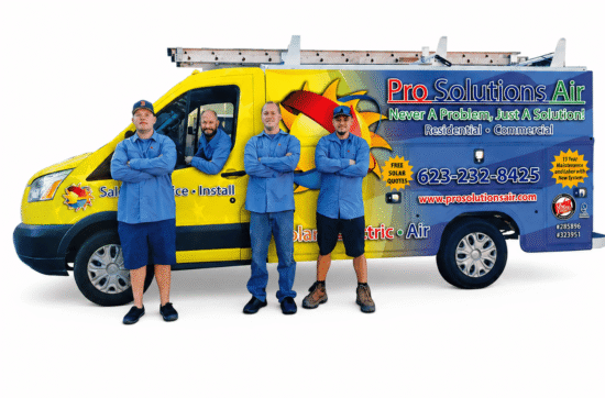 A yellow and blue service van with a ladder on top and "Pro Solutions Air Conditioning and Heating Inc." graphics. Three male technicians stand with arms crossed in front of the van, while a fourth technician sits in the driver's seat. All are wearing blue uniform shirts. The van displays contact information, including the phone number 623-232-8425, the website www.prosolutionsair.com, and "Residential • Commercial" services. The company's tagline, "Never A Problem, Just A Solution!", is visible, along with logos for solar quotes and "Pro Solutions Air Conditioning and Heating Inc." branding.