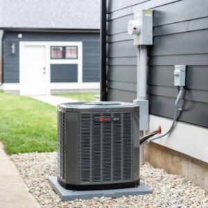 Outdoor Trane air conditioning condenser unit installed on a gravel pad