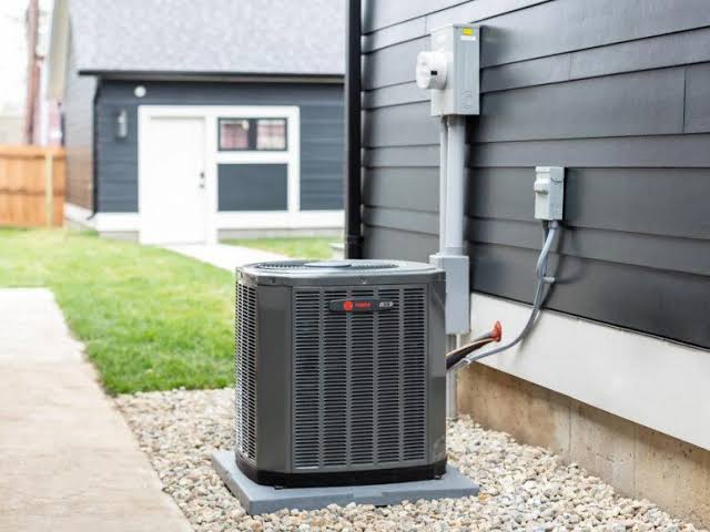 Outdoor Trane air conditioning condenser unit installed on a gravel pad